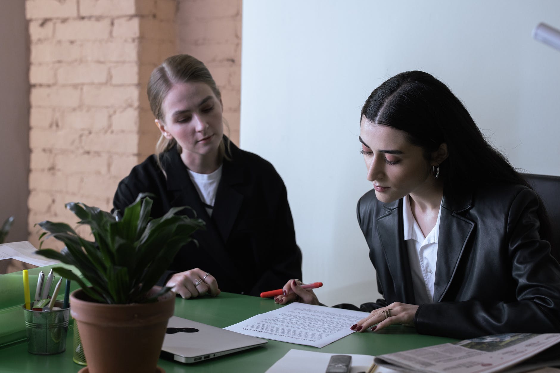 women looking at the document on the table